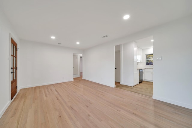 spare room featuring light wood-type flooring