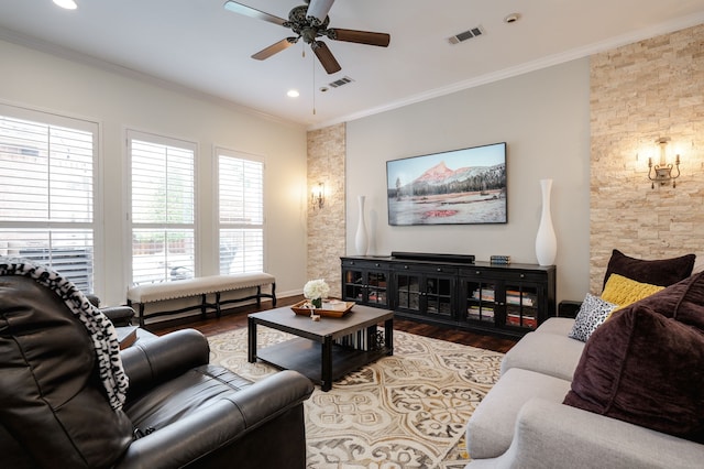 living room with crown molding, wood-type flooring, and ceiling fan