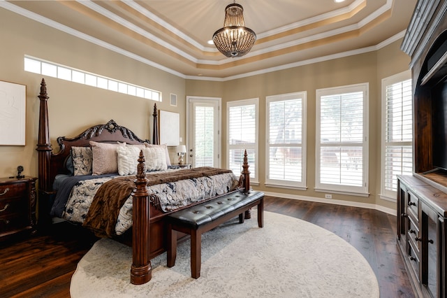 bedroom with multiple windows, dark hardwood / wood-style floors, crown molding, and a raised ceiling