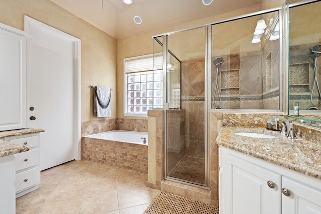 bathroom featuring tile patterned floors, separate shower and tub, and vanity