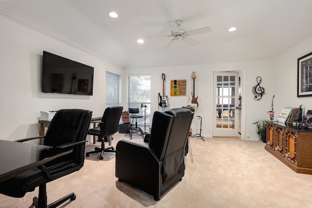 office area with crown molding, vaulted ceiling, ceiling fan, a tray ceiling, and light colored carpet