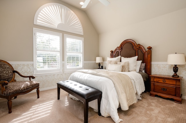 bedroom with ceiling fan, light colored carpet, and lofted ceiling