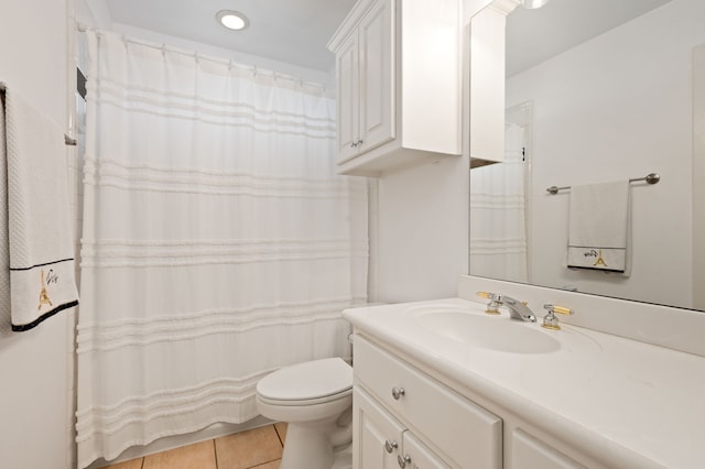 bathroom featuring vanity, tile patterned floors, and toilet