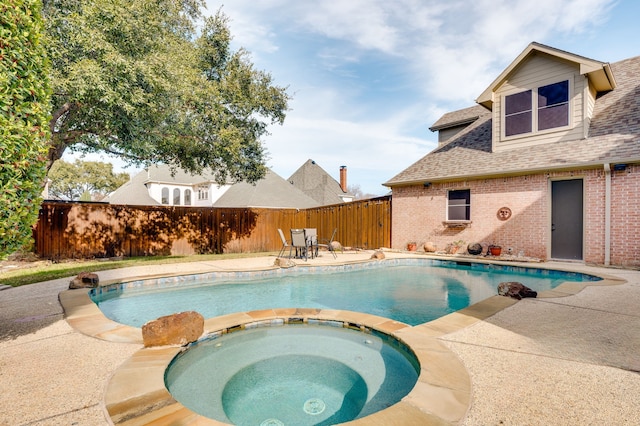 view of swimming pool featuring an in ground hot tub and a patio area