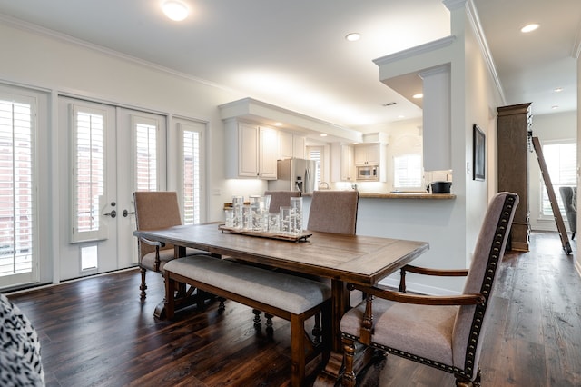 dining room with ornamental molding, dark wood-type flooring, and french doors