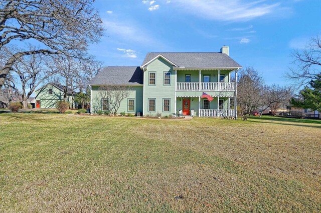 view of front of home featuring covered porch and a front lawn