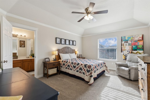 carpeted bedroom featuring ceiling fan, ensuite bath, a tray ceiling, and crown molding