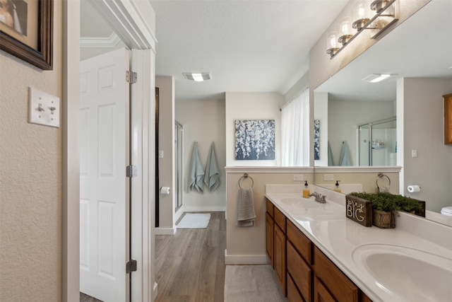 bathroom featuring vanity, hardwood / wood-style floors, and an enclosed shower