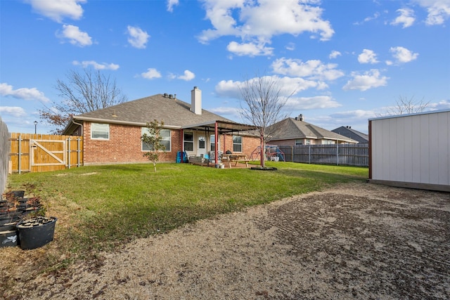 rear view of house featuring a shed, a yard, and a patio