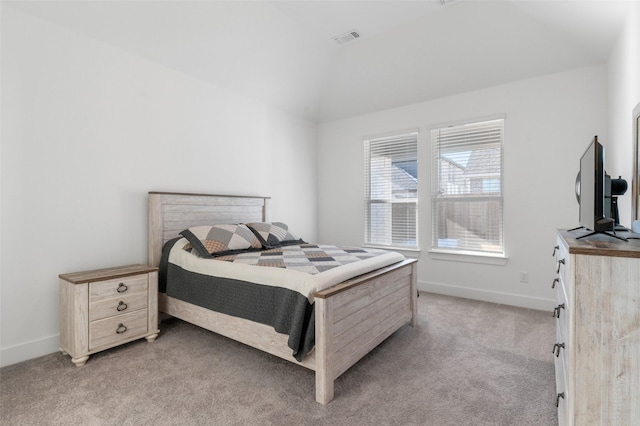 bedroom featuring light carpet and lofted ceiling