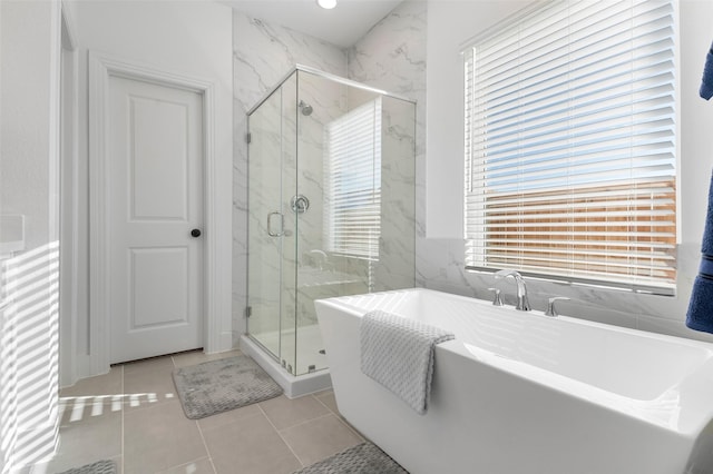 bathroom featuring plus walk in shower and tile patterned floors