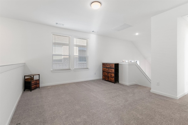 empty room with light carpet and lofted ceiling