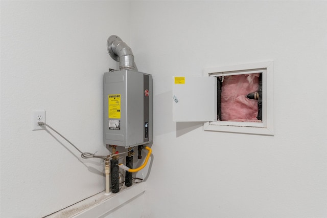 utility room featuring water heater