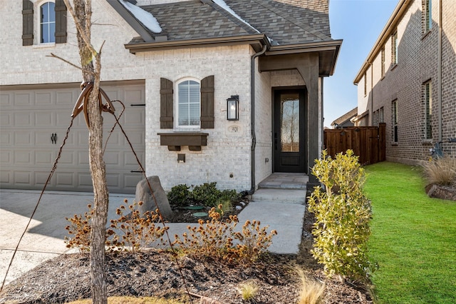 view of front facade featuring a front lawn, an attached garage, fence, and roof with shingles