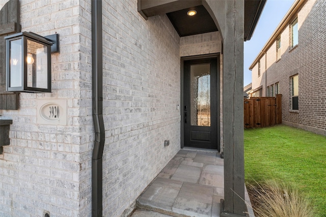 doorway to property featuring a yard