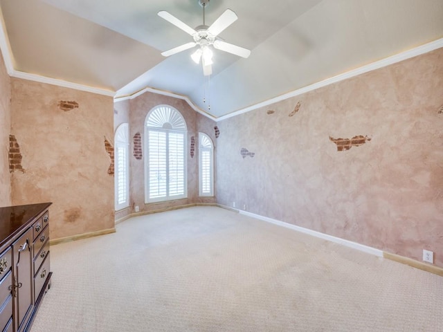 carpeted empty room with crown molding, lofted ceiling, and ceiling fan