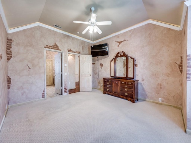 unfurnished bedroom featuring ceiling fan, ornamental molding, light colored carpet, and lofted ceiling