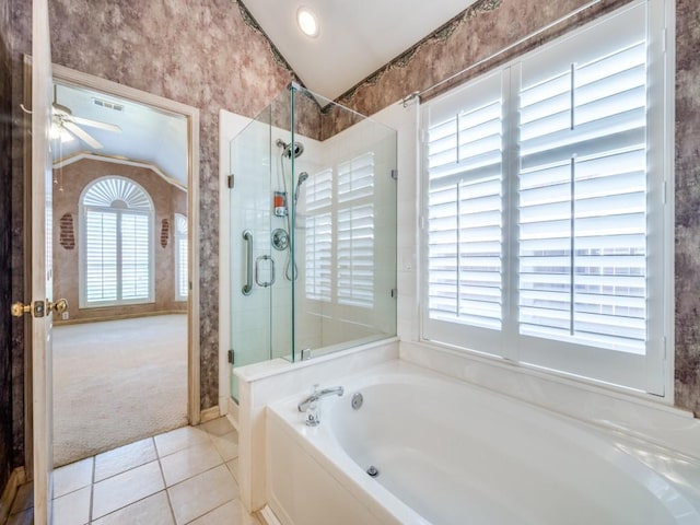 bathroom with a wealth of natural light, vaulted ceiling, tile patterned floors, and ceiling fan