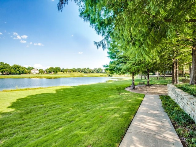 view of community featuring a lawn and a water view