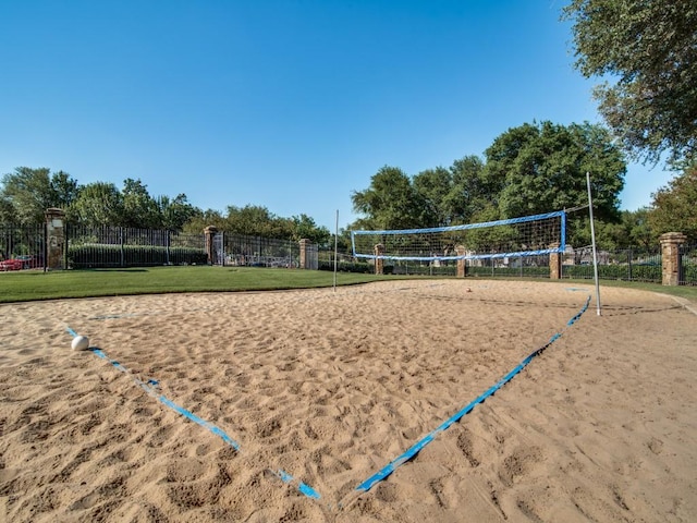 view of property's community featuring a yard and volleyball court