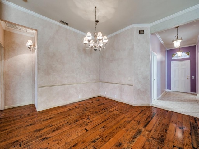 unfurnished dining area with an inviting chandelier, wood-type flooring, and ornamental molding