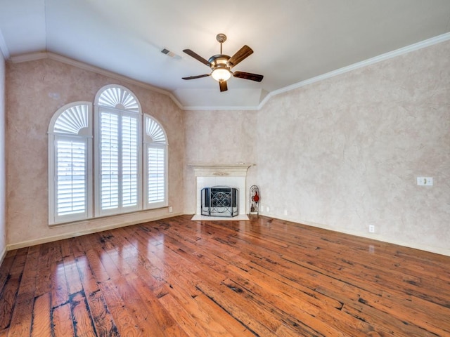 unfurnished living room featuring hardwood / wood-style floors, vaulted ceiling, and ornamental molding