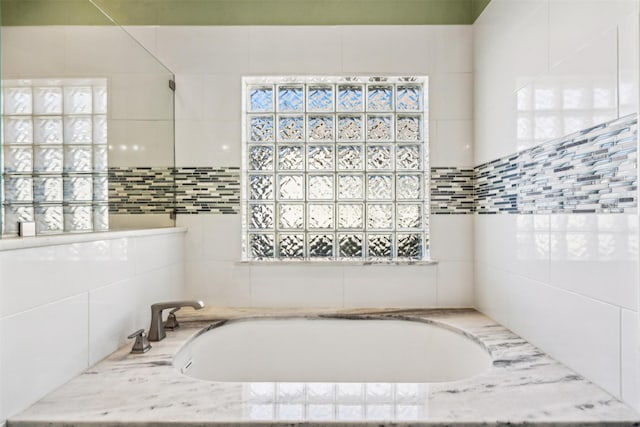 bathroom with tiled bath