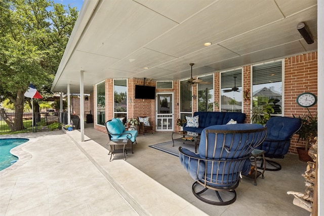 view of patio / terrace featuring ceiling fan, a fenced in pool, and an outdoor living space