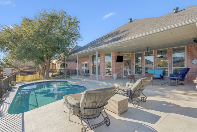 view of pool with outdoor lounge area, ceiling fan, and a patio