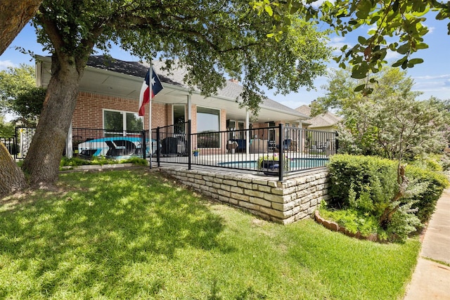 view of swimming pool featuring a lawn and a patio area