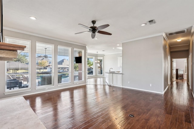 unfurnished living room featuring dark hardwood / wood-style flooring, crown molding, and ceiling fan