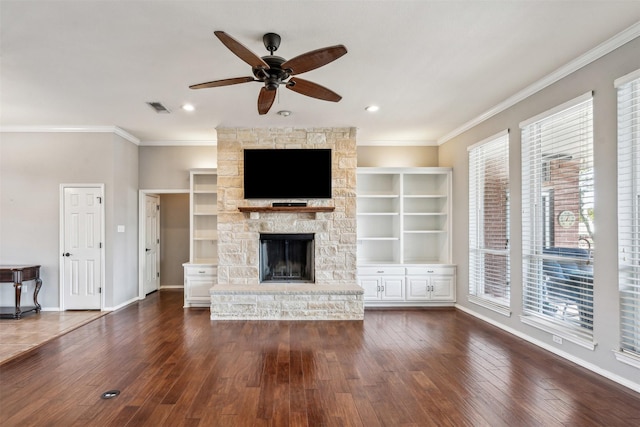 unfurnished living room featuring ceiling fan, dark hardwood / wood-style floors, ornamental molding, and a fireplace