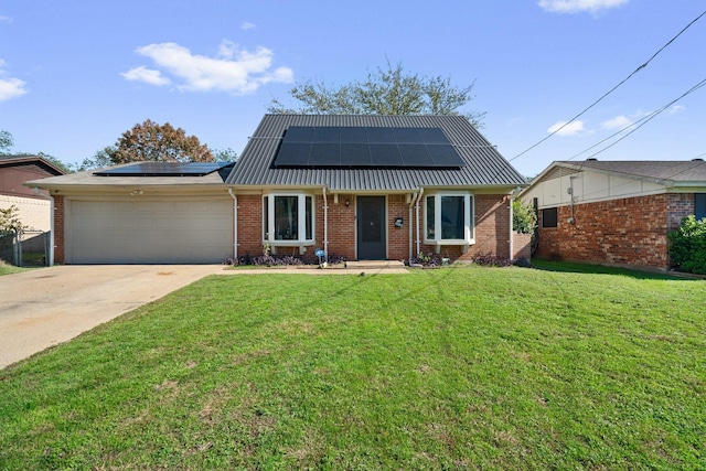 view of front facade featuring a garage, a front yard, and solar panels