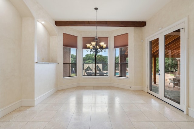 unfurnished dining area with french doors, beamed ceiling, light tile patterned floors, and an inviting chandelier