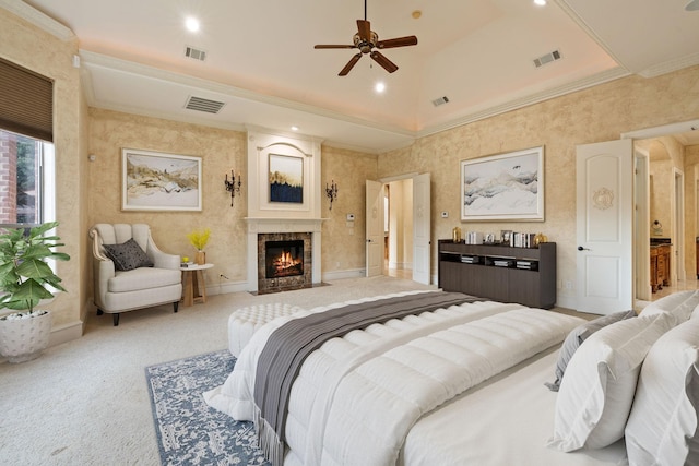 bedroom with carpet flooring, ornamental molding, ceiling fan, a fireplace, and a high ceiling