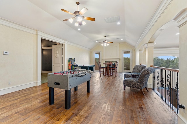 playroom featuring ornate columns, vaulted ceiling, ceiling fan, crown molding, and wood-type flooring