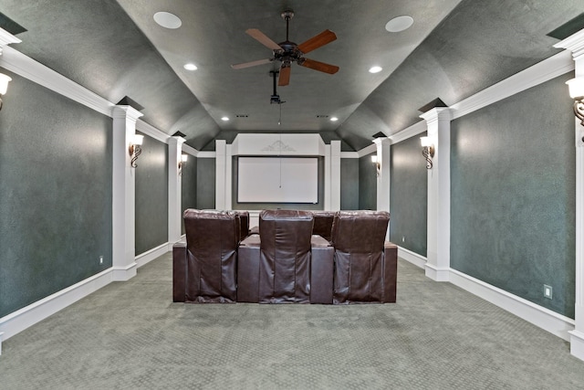 carpeted cinema room with ceiling fan, lofted ceiling, ornamental molding, and ornate columns