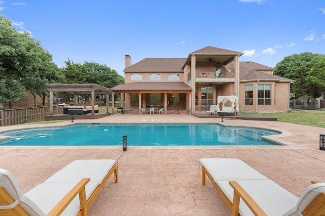 view of pool with a pergola, ceiling fan, a patio, and an outdoor hangout area