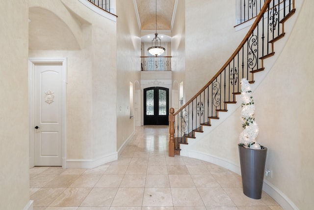 entrance foyer featuring a towering ceiling and french doors