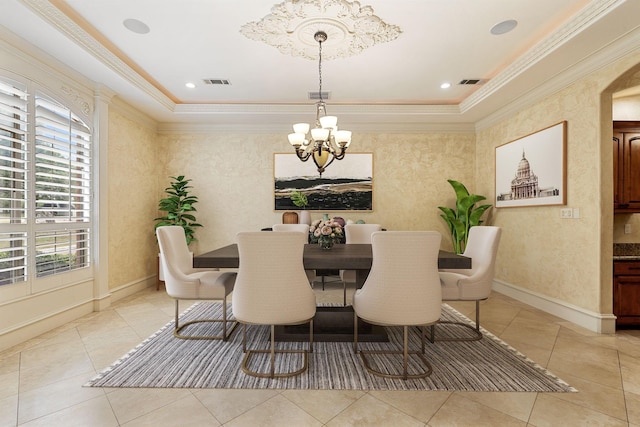 dining area with a notable chandelier, a raised ceiling, light tile patterned floors, and ornamental molding