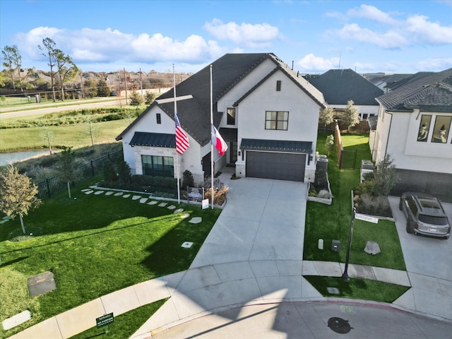 view of front of home featuring a front yard and a garage