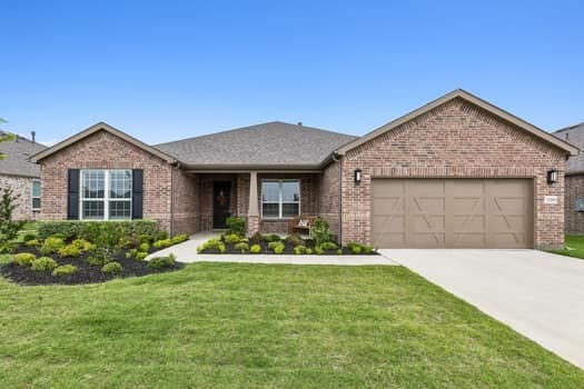 view of front of home featuring a garage and a front lawn