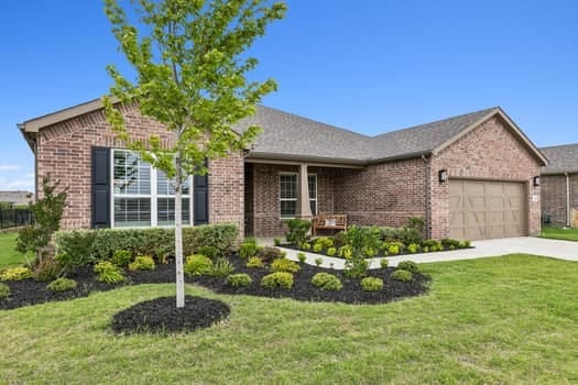 ranch-style house featuring a garage and a front yard