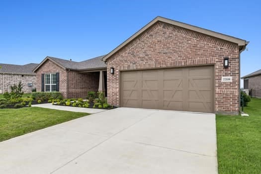 view of front of house with a garage and a front yard