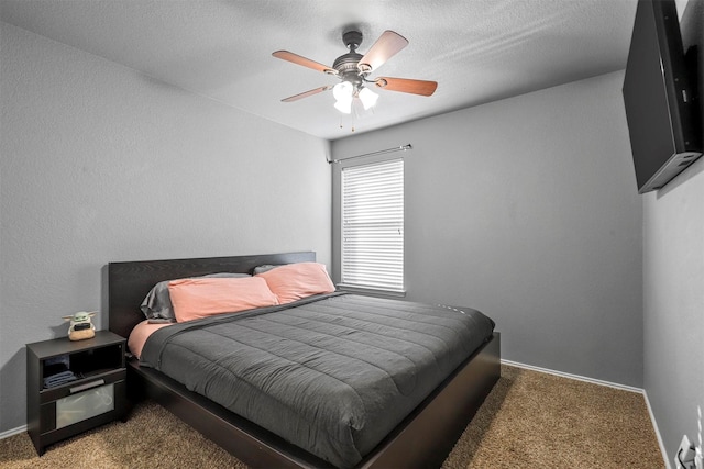 bedroom with ceiling fan and dark colored carpet