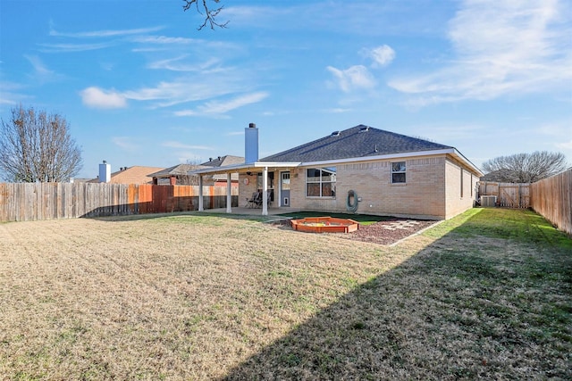 rear view of property featuring a patio area and a lawn