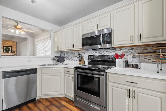 kitchen with white cabinets, stainless steel appliances, and sink