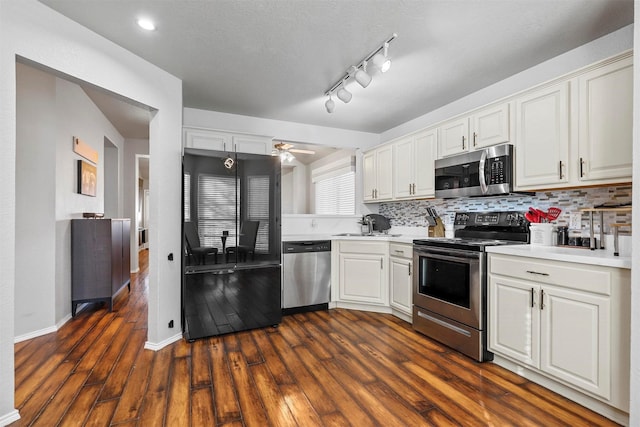 kitchen with white cabinetry, ceiling fan, tasteful backsplash, dark hardwood / wood-style flooring, and appliances with stainless steel finishes