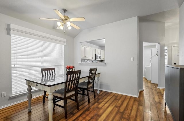 dining room with dark hardwood / wood-style flooring, a wealth of natural light, lofted ceiling, and ceiling fan