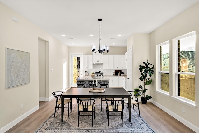 dining room with an inviting chandelier and light hardwood / wood-style floors